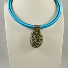 Black and white pebble pendant on blue cord